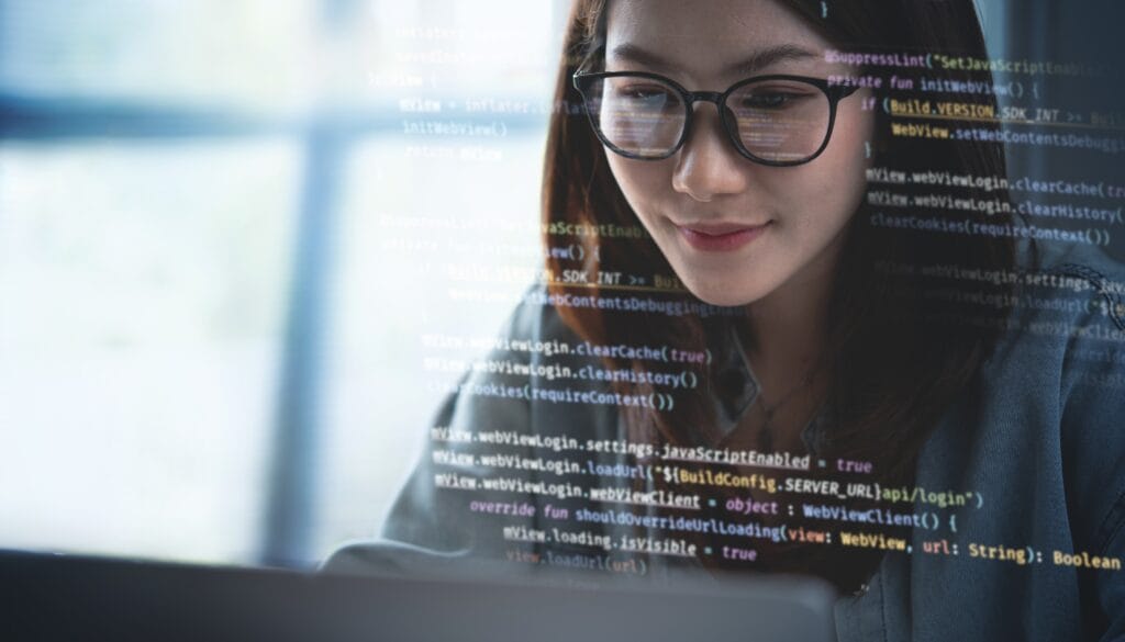 female programmer looking at code