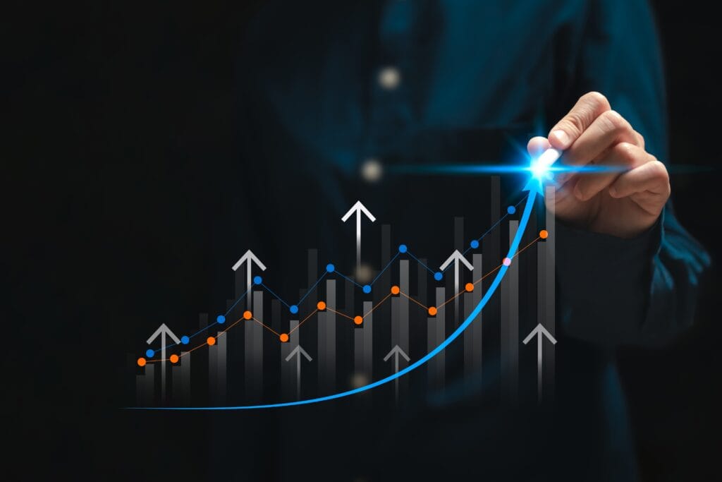business person drawing a upward graph
